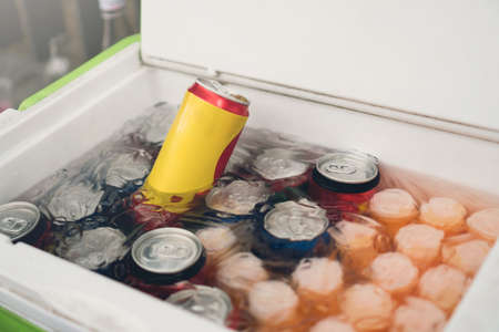 Cans of soft drinks in an ice box.の写真素材