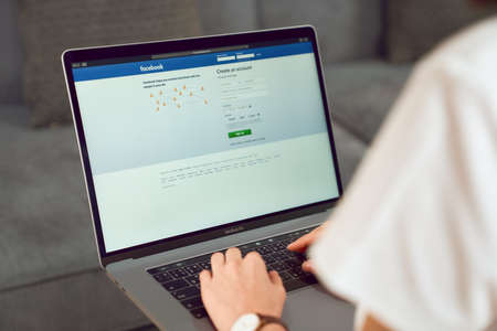 Bangkok, Thailand -  September 5 2020 : Woman hand is pressing the Facebook screen on apple Macbook Pro, Social media are using for information sharing and networking.のeditorial素材