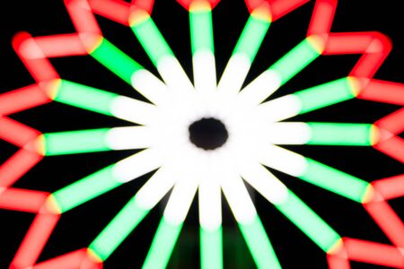 Blurred light of Ferris wheel for festival backgroundの写真素材