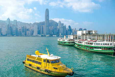 HONG KONG - DECEMBER 11, 2016: View of Hong Kong skyline over Victoria Harbour, the financial heart center of Asia, is very beautiful scene while the shipping boat is crossing through to bay.の写真素材