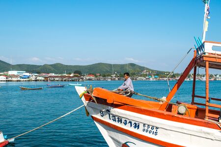 Chonburi , Thailand - January 1, 2018: A man work on the boat at the concrete jetty of Sattahip, Chonburi province, Thailandのeditorial素材