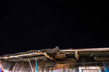 Roof and stars in the night sky background and textureの写真素材