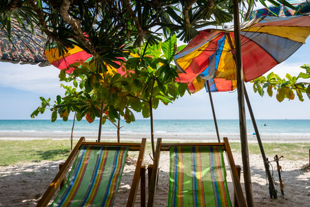 Mae Ram Phueng Beach, the beautiful and quiet for relaxation on the good holiday, is the attractions in Rayong, Thailand.  There are two seats on the front beach that under the palm trees,の写真素材