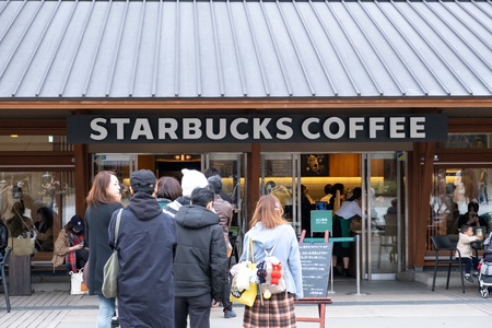 Tokyo, Japan - March 17, 2019:View of customers waited in the queue at Starbucks Coffee Ueno Onshi Park during pink cherry blossom or Sakura spring season in Tokyo, Japan.のeditorial素材