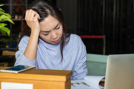 Asian women with black hair wear sweet cloth work hard with serious issue with thinking a idea for...