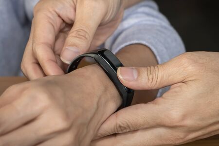 Holding and wearing smartwatch into the sweetness hand for healthy and health care with modern...