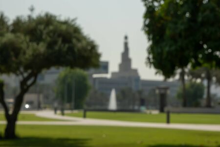 Blurred background of Al Fanar Islamic Cultural Center with green park in Doha, Qatar.