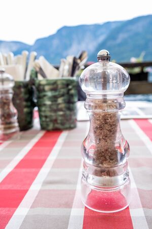 Hallstatt local Salt Shaker on the table at a romantic restaurant beside the Hallstatter See Lake in High Alps Mountains, a  famous romantic place European travel lakeside destination in  Austriaの写真素材