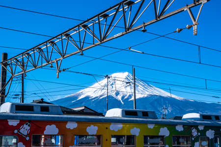 Yamanashi, Japan - March 24, 2019 : View of Mount Fuji, commonly called Fuji san in Japanese, Mount Fuji's exceptionally symmetrical cone, from a train station in Yamanashi, Japan.のeditorial素材