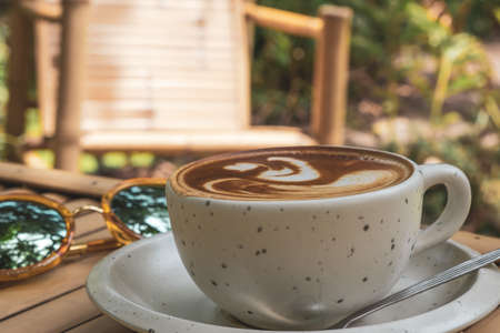 Cappuccino Recipe Mug, espresso based coffee drink traditionally prepared with steamed milk foam, concept background in retro vintage natural garden showing the lifestyle design and creative timeの写真素材