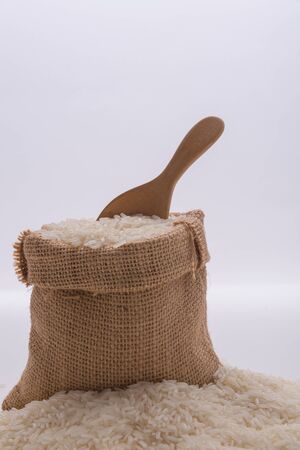 Rice in a bag with a wooden spoonの写真素材