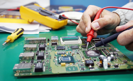 Maintenance support and repairing service concept. Electronic circuit board inspecting close up....