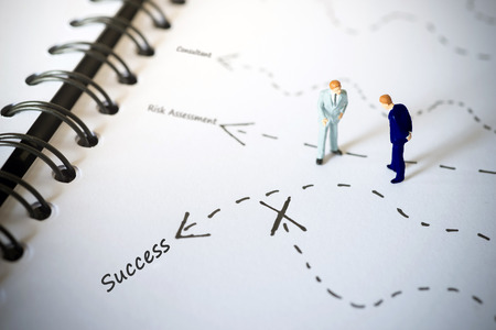Businessmen standing and giving advice with arrow to success.の写真素材