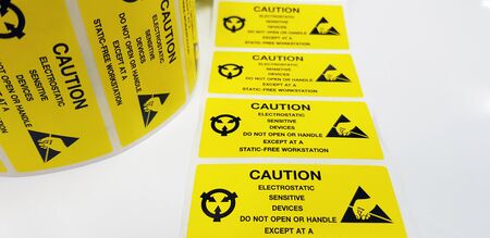 Yellow caution label,Standard caution label with text "Caution" for Electrostatic Sensitive Devices (ESD) in electronic industrial,Special label symbol for electrostatic sensitive devicesの写真素材