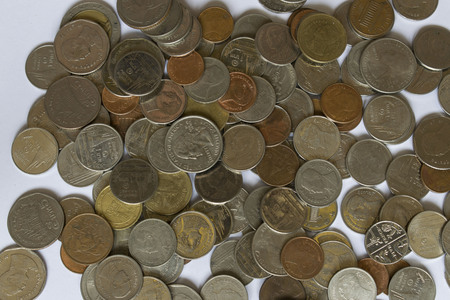 Many coins on white backgroundの写真素材
