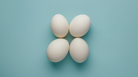 Four white eggs arranged in a plus sign (+) on a blue background.の素材