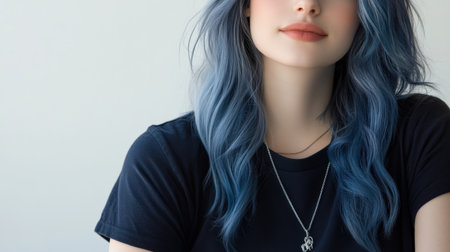 Close up of beautiful woman with white skin, blue long hair, wavy hair and a clear black t shirt, isolated in a light white studio. Portrait person.の素材