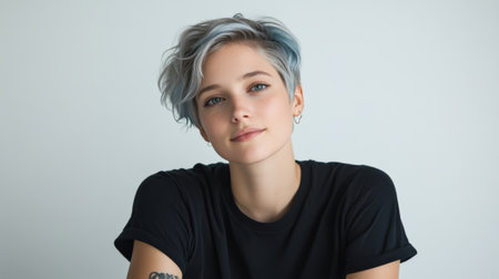 Close up of beautiful woman with white skin, blue short hair, wavy hair and a clear black t shirt, isolated in a light white studio. Portrait person.の素材