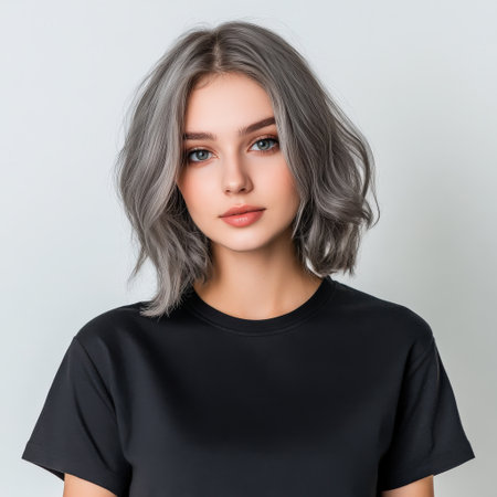 Close up of beautiful woman with white skin, grey short hair, wavy hair and a clear black t shirt, isolated in a light white studio. Portrait person.の素材