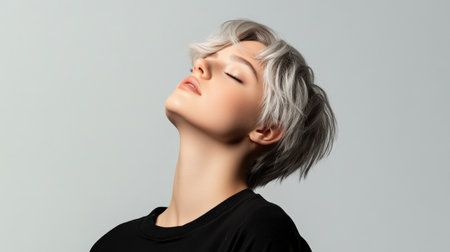 Close up of beautiful woman with white skin, grey short hair, wavy hair and a clear black t shirt, isolated in a light white studio. Portrait person.の素材