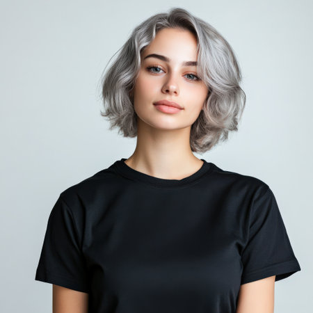 Close up of beautiful woman with white skin, grey short hair, wavy hair and a clear black t shirt, isolated in a light white studio. Portrait person.の素材