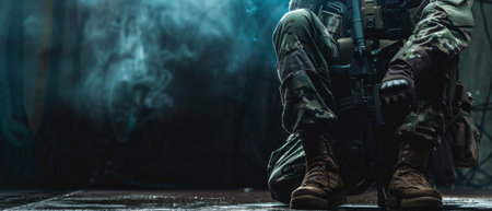 A soldier wearing camouflage uniform and tactical vest is kneeling on the ground in a dark room.の素材
