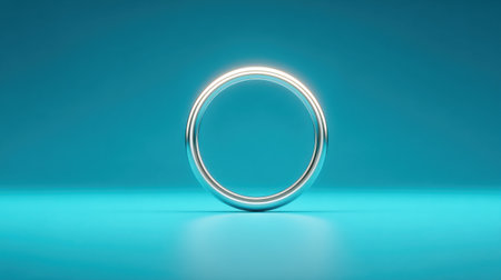 A silver ring is shown on a blue background. The ring is the only object in the image, and it is the main focus. The blue background gives the image a calm and serene moodの素材