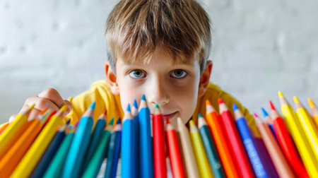 Cute little boy drawing with colorful pencils at home, closeupの素材