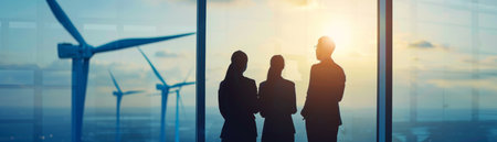 Three business people are looking at wind turbines from the office window.の素材