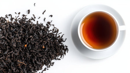 A cup of tea sits on a white plate next to a pile of tea leaves. Concept of relaxation and comfort, as the tea and leaves are often associated with calming and soothing experiencesの素材