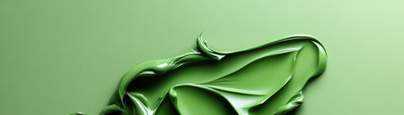 A green blob of paint is on a green background. The blob is thick and has a lot of textureの素材