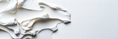 A white blob of paint is spread across a white background. The paint appears to be thick and creamy, with a texture that suggests it might be a type of frosting or whipped creamの素材