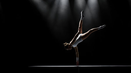 A woman is doing a handstand on a stage. The image is in black and white and the woman is the main focus. Scene is energetic and dynamic, as the woman is performing a challengingの素材