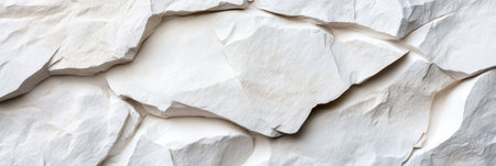 A white rock wall with a lot of cracks and holes. The wall is made of stone and has a rough textureの素材