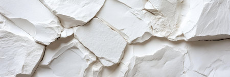 A white wall with a lot of cracks and holes. The wall is made of stone and looks like it has been damagedの素材