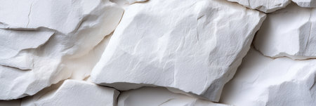 A white rock with a jagged edge. The rock is white and has a rough texture. It is a natural stone that has been weathered by the elements. The rock is a symbol of strength and resilienceの素材