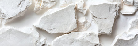 A white rock wall with a white background. The wall is made of small white rocks. The wall is very rough and has a lot of textureの素材