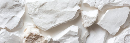 A large white rock with many small white rocks scattered around it. Scene is one of ruggedness and strength, as the large rock stands out against the smaller rocksの素材