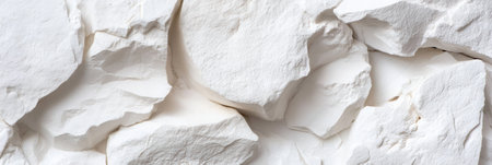 A white rock wall with a lot of white rocks. The rocks are all different sizes and shapesの素材