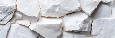 A wall made of white rocks with some cracks. The wall is made of white rocks and has a few cracks, giving it a rugged and natural appearanceの素材