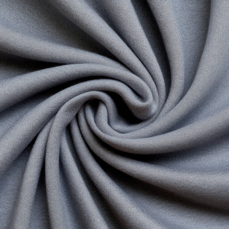 A blue fabric with a spiral pattern. The fabric is made of a soft material and has a smooth textureの素材