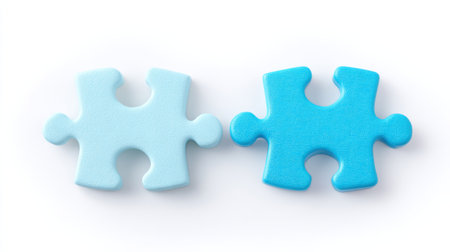 Two blue puzzle pieces on a white background. The blue pieces are connected to each other. Concept of unity and connectionの素材