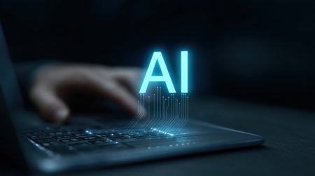 A person is typing on a laptop with the word AI glowing in the background. Concept of technology and the importance of artificial intelligence in our daily livesの素材