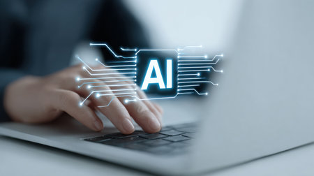 A person is typing on a laptop with the word AI in the foreground. Concept of technology and the importance of artificial intelligence in our daily livesの素材