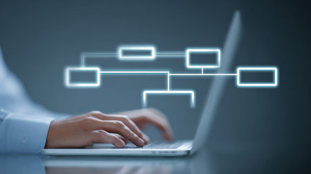 A person is typing on a laptop with a diagram of a network on the screen. Concept of technology and the importance of communication and connectivity in today's world. Scene is focused and professionalの素材