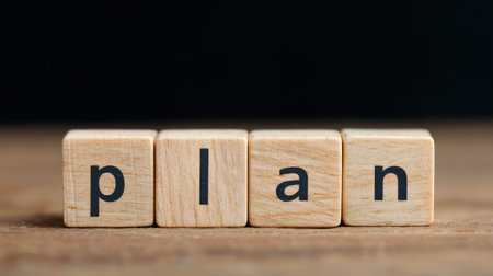 A wooden block with the word "plan" written on it. The blocks are arranged in a row, with each block slightly overlapping the one below it. Scene is simple and straightforwardの素材