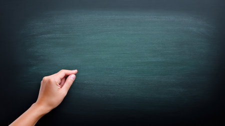 A hand is drawing on a chalkboard. The chalkboard is green and the hand is whiteの素材