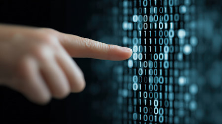 A hand pointing at a series of binary numbers. Concept of technology and the importance of understanding binary code. Scene is serious and focused, as the hand is the only element in the sceneの素材