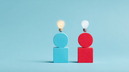 Two people are standing on top of two blocks, one blue and one red. The blocks are stacked on top of each other, and the people are lit up like light bulbs. Concept of creativity and innovationの素材