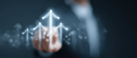 A man is pointing at a series of arrows on a screen. The arrows are pointing upwards, and the man is pressing a button to make them appear. Concept of progress and growthの素材